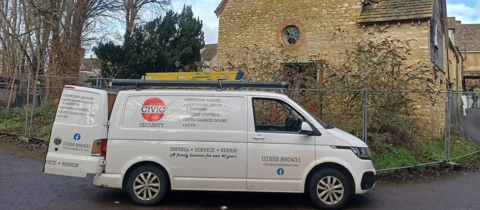 Civic Security van beside a stone building