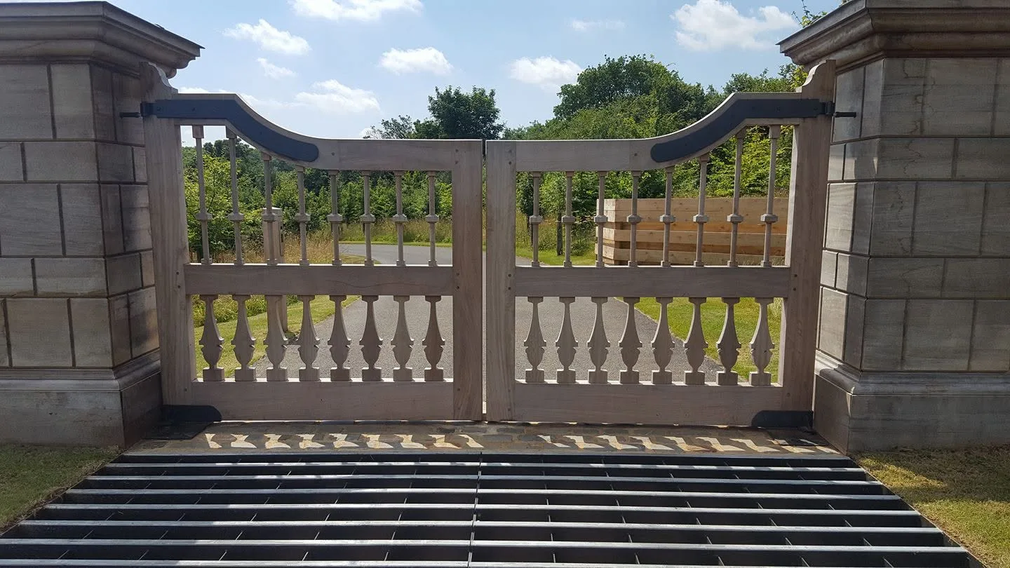 Pair of timber entrance gates with decorative metalwork